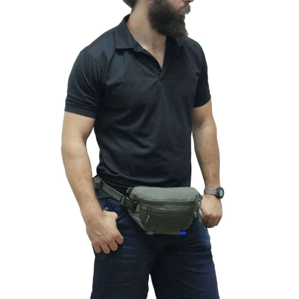 Agilite Six Pack pouch worn as a waist pack, in olive drab fabric with a front zipper pocket and black straps.