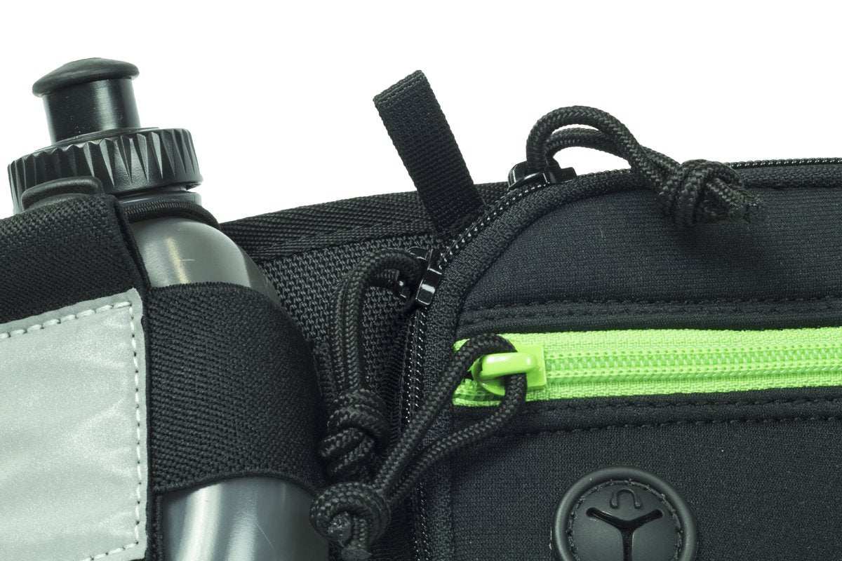 Marathon Gun Pack running belt in black nylon with a neon green zipper, reflective panel and water bottle